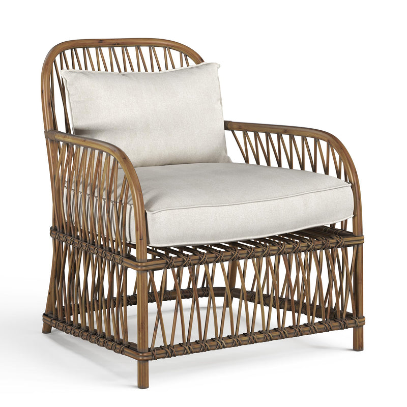 3/4 view of a Natural Rattan Occasional Chair with Linen cushions in a Coastal Style from the Byron range by House of Curators
