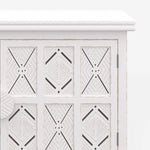 Close up view of the door of a Sideboard made from solid wood in a rustic white finish with carved doors from the Southampton range by House of Curators